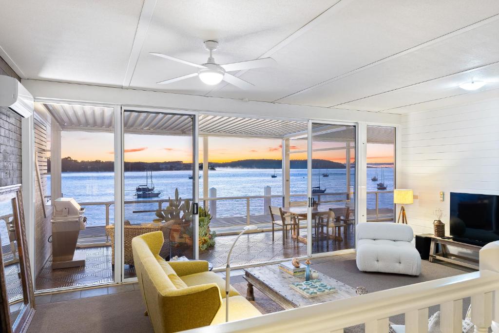 a living room with a view of the water at Bay Breeze Boutique Accommodation in Batemans Bay