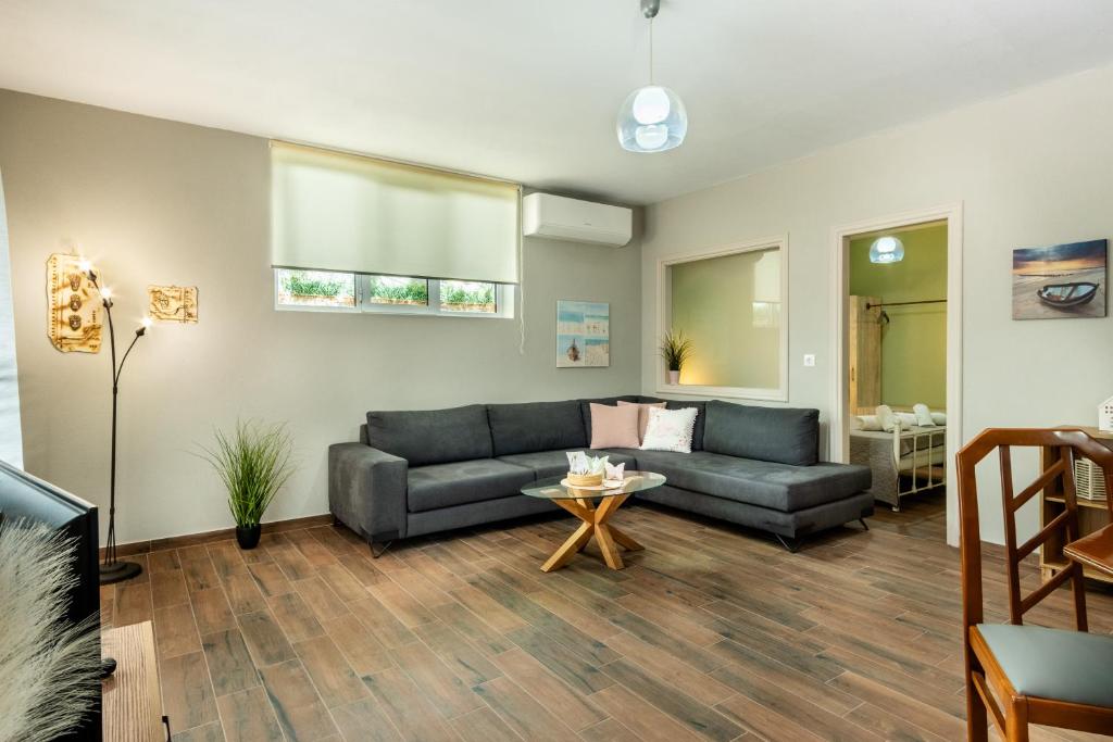 a living room with a couch and a table at Elia Grove House in Néa Khilí