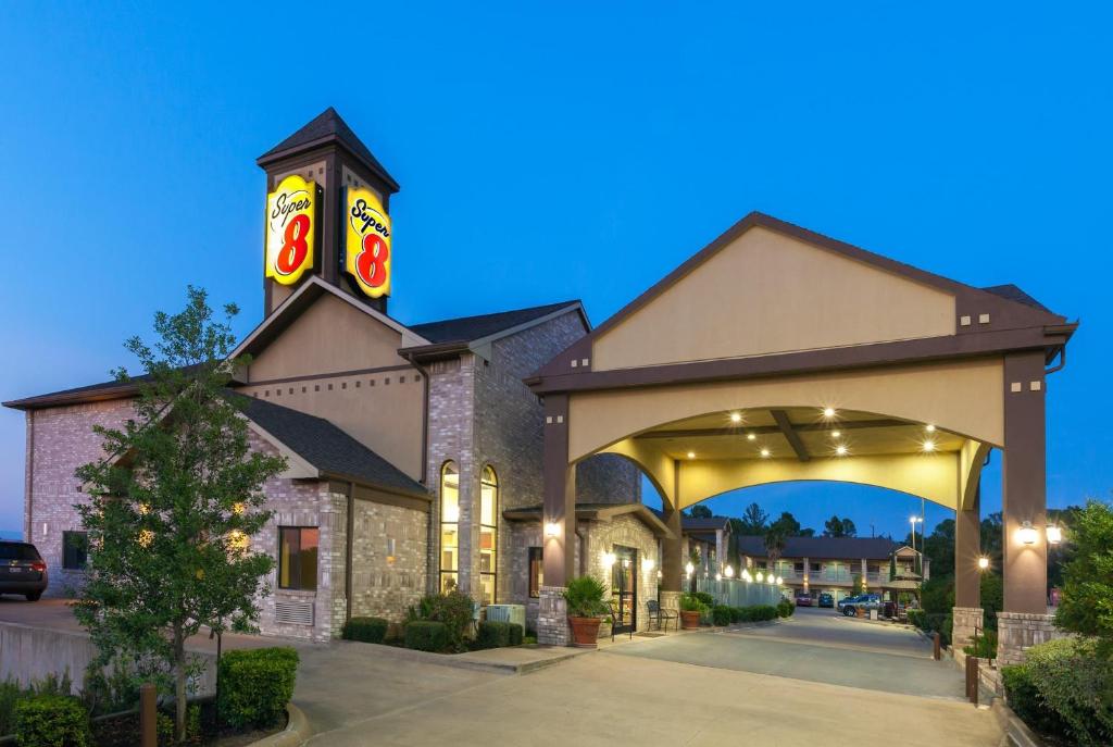 a large building with an archway in front of it at Super 8 by Wyndham Fairfield Tx in Fairfield