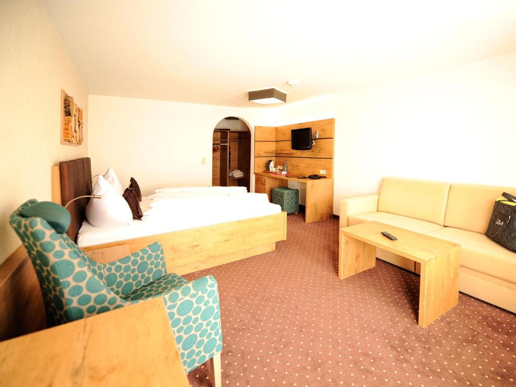 Postel nebo postele na pokoji v ubytování Hotel Röck Garni