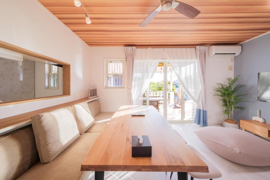 a living room with a couch and a table at Halema in Ichinomiya