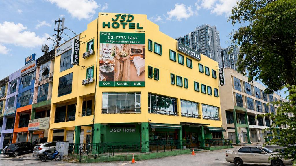 a yellow building with an advertisement for a hotel at JSD Hotel in Petaling Jaya