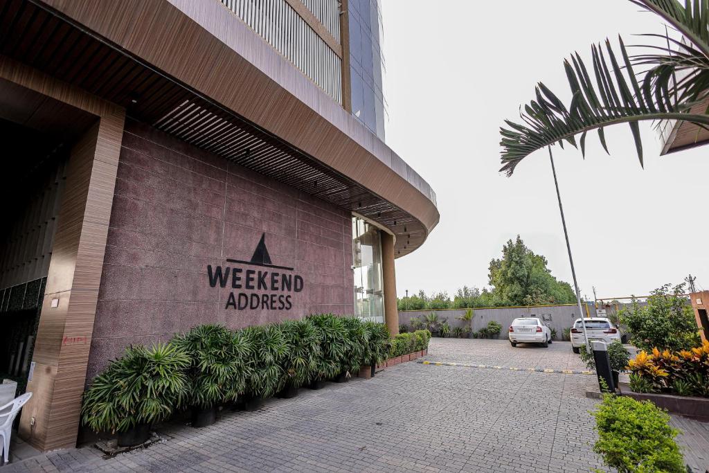 a building with a sign that reads weekend adidas at Weekend Address By Farmville in Surat