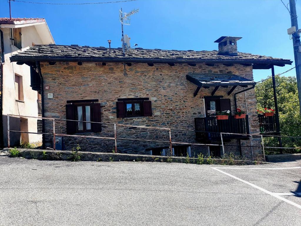 a small brick building with windows on a street at Gran Paradiso in Alpette