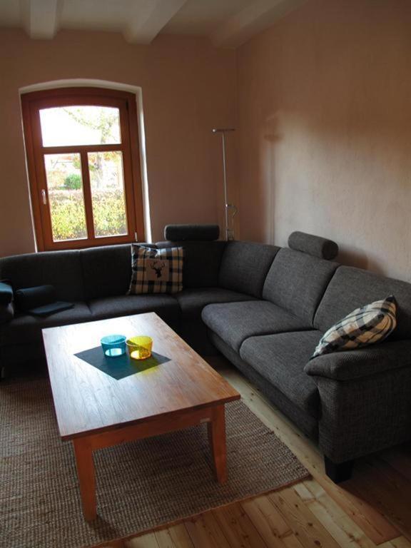 a living room with a couch and a coffee table at Ferienhaus Altes Schifferhaus in Oedelsheim