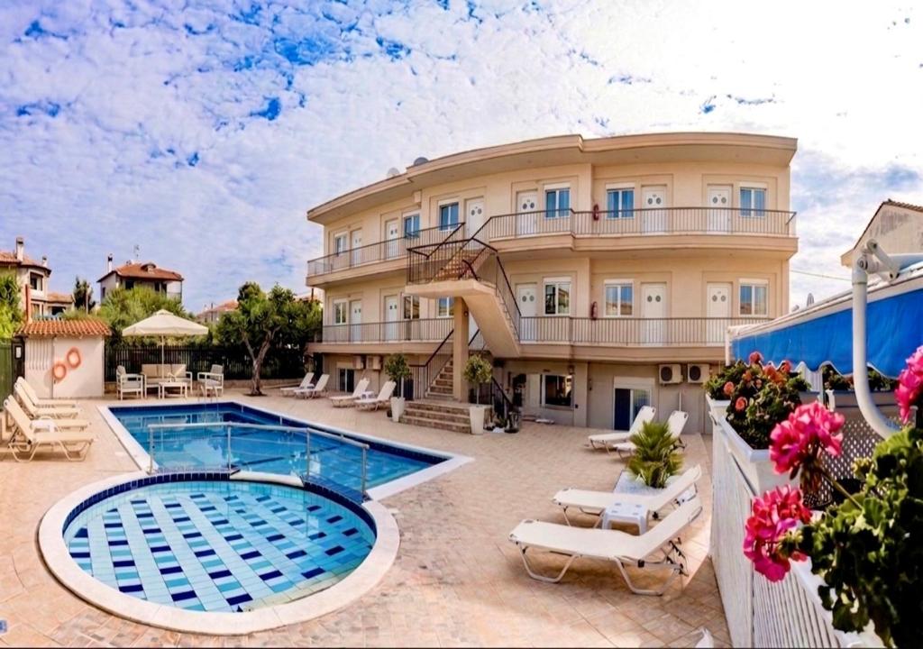 a resort with a swimming pool and a building at Brother's House in Kallithea Halkidikis