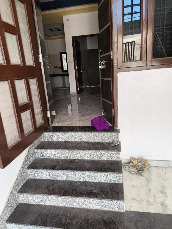 a room with stairs with a purple bag on the floor at Bari Mata home ste in Lakāwās