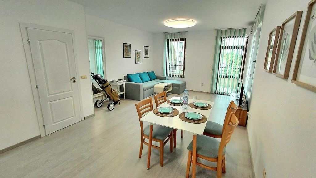 a living room with a table and chairs and a couch at Luxury Lighthouse Golf Apartment in Balchik