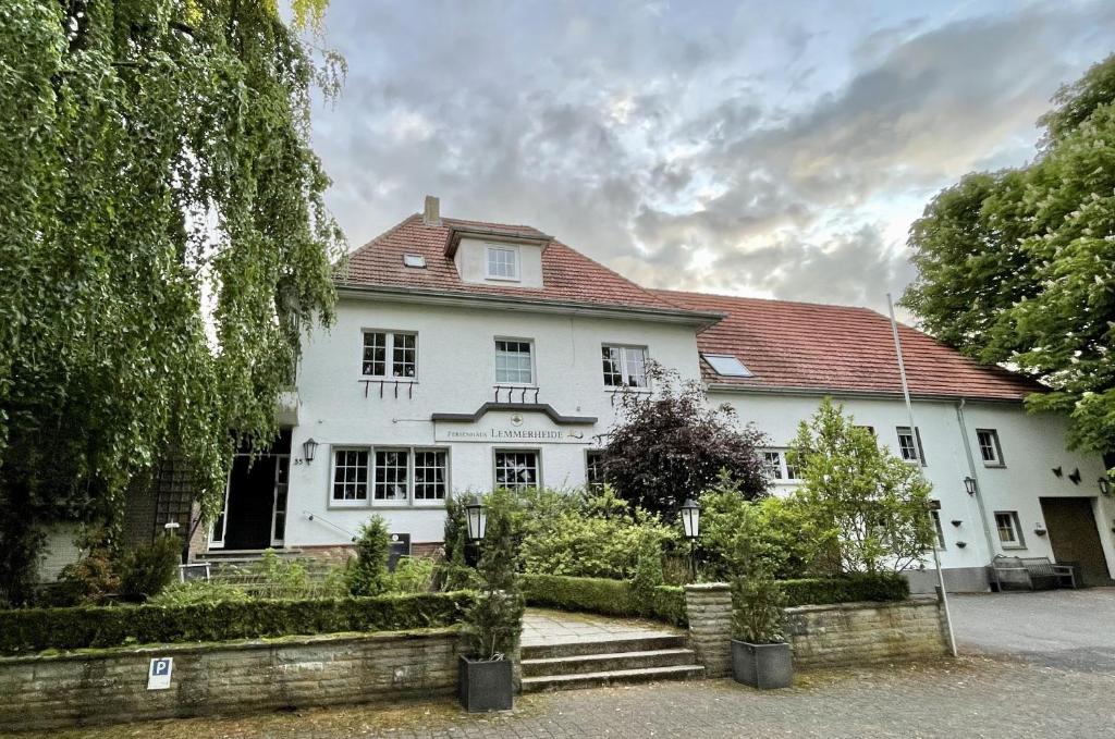 a white house with a red roof at Ferienhaus Lemmerheide in Rüthen