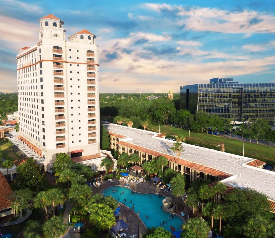 an aerial view of a large white building with a pool at DoubleTree by Hilton Orlando Theme Park Resort in Orlando