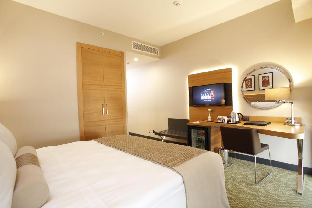 Postel nebo postele na pokoji v ubytování Mia City Hotel
