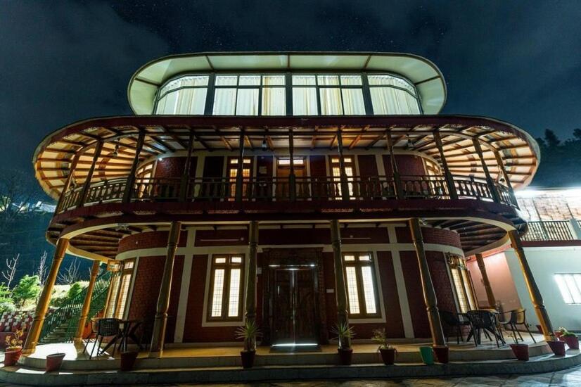 a round building with a balcony on top of it at Jhumelo Homestay, Ukhimath in Ukhimath