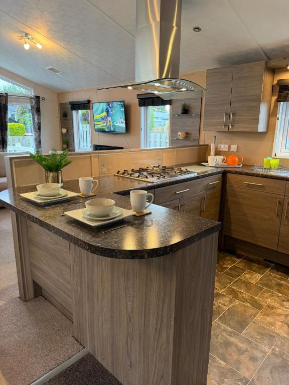 a kitchen with a large island in the middle at Southerness Holiday Home Cheri Sleeps 4 Mon-Fri Fri-Mon with Solway Holiday Homes in Mainsriddle