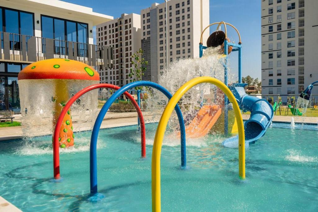 a water park with a water slide in a pool at Sky Luxury Residence, 12th Floor, Panoramic in Guadalajara