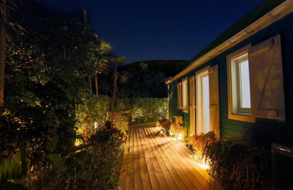 a deck with lights on the side of a house at Villa Eugénie in Gustavia