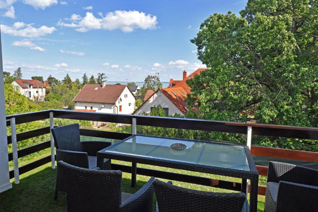 a patio with a table and chairs on a balcony at Blackbird Apartment in Balatonfüred