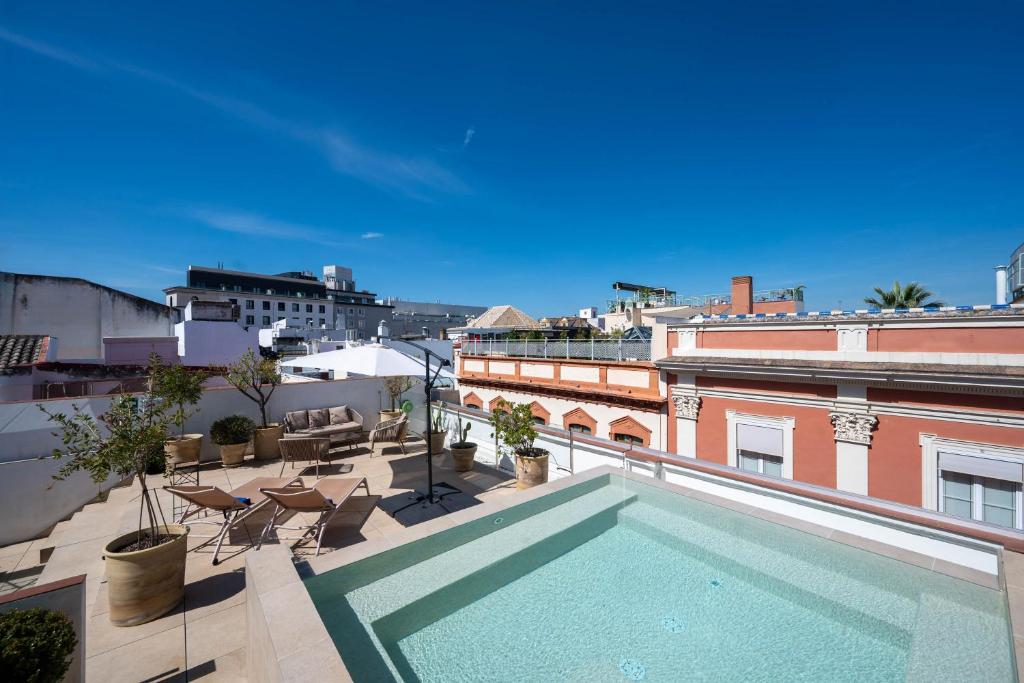 a swimming pool on the roof of a building at Hotel Boutique Casa Romana Villa in Seville