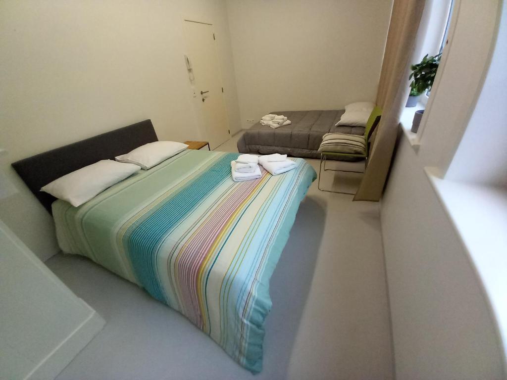 a small room with a bed and a couch at Chez Jean-Claude chambre double in Wavre
