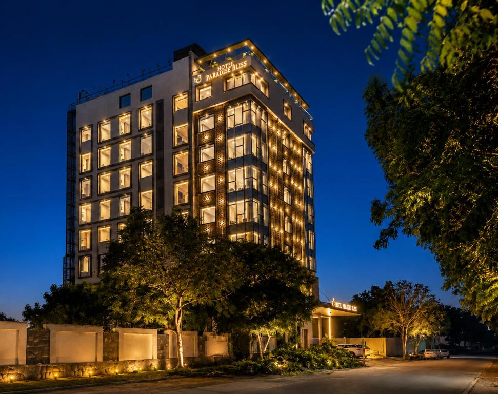 a tall building with lights on it at night at Paradise Bliss Udaipur - Luxury Boutique Hotel in Udaipur