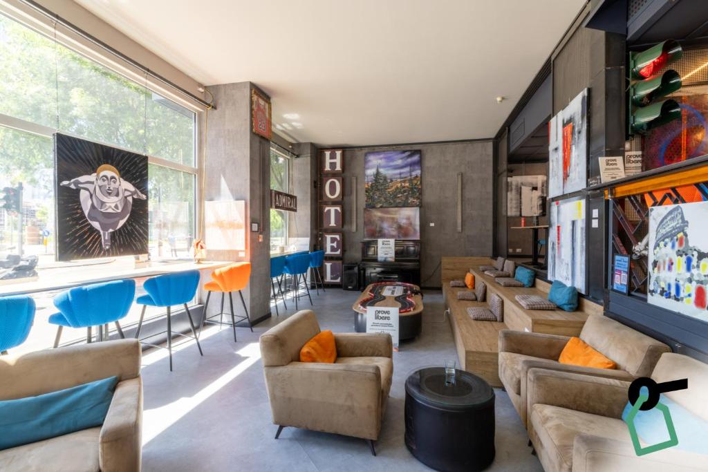 a living room with couches and chairs and a table at Hotiday Milano CityLife in Milan