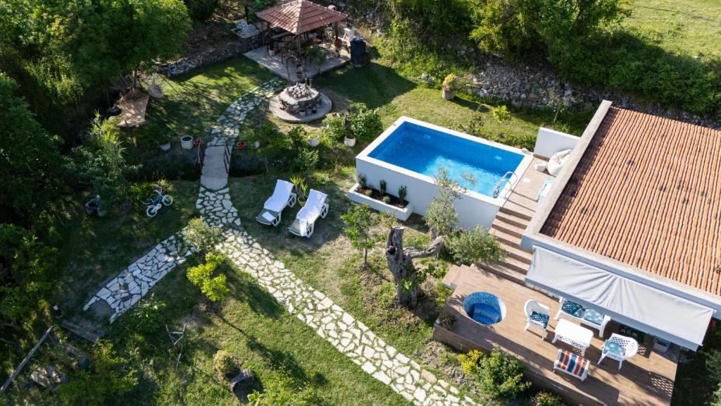 an aerial view of a house with a swimming pool at Nature Oasis Kravari - Private Pool & Jacuzzi in Stegvaši