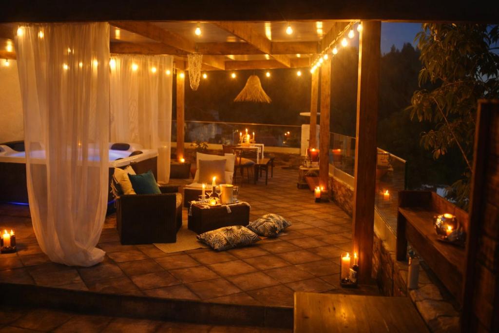 a patio with candles and lights on a deck at A Encantada Spa e Vista 180 Casa de Artista in Alqueve