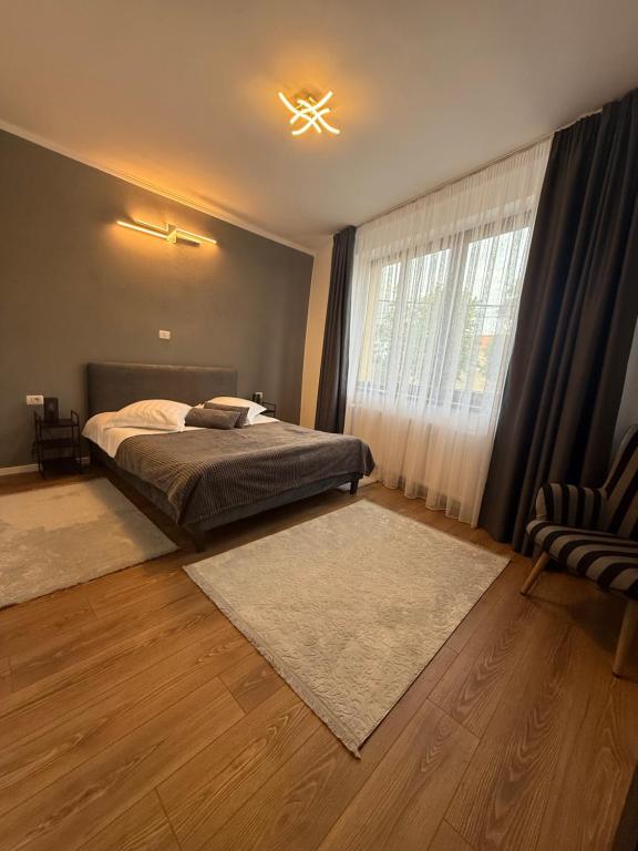 a bedroom with a bed and a window at Castle View Apartments in Făgăraş