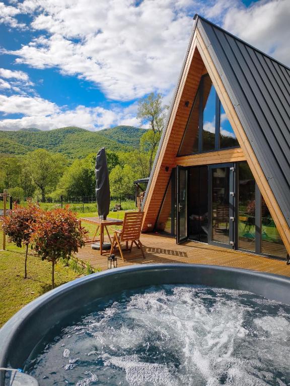 a house with a hot tub in the yard at Transylvantures Cabin in Rimetea