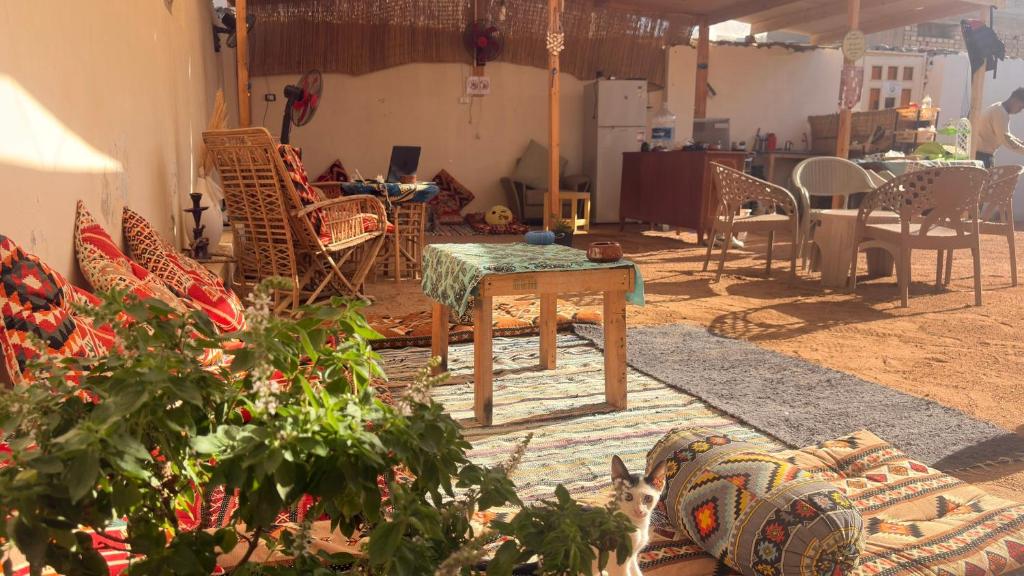 a living room with chairs and a table and a table sidx sidx at SafeZone Guesthouse in Dahab