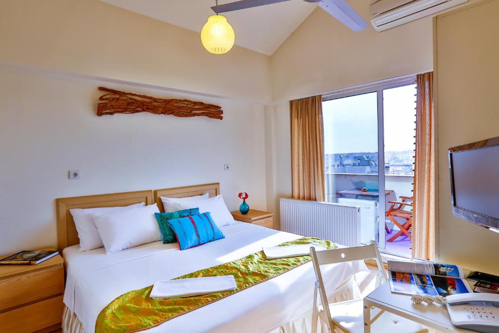 a bedroom with a bed and a desk and a television at Han Hotel Istanbul in Istanbul