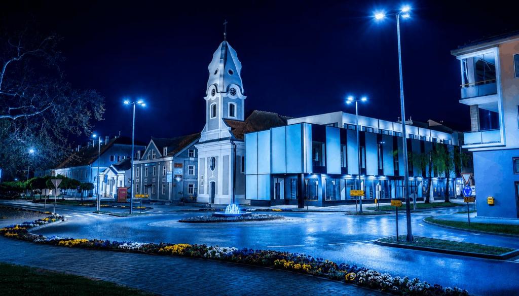 a large white church with a tower at night at Tiona in Nova Gradiška