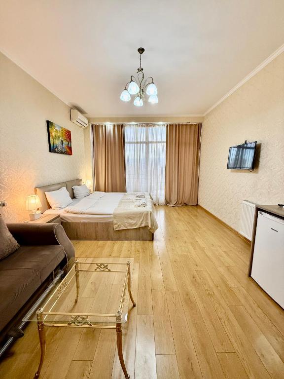 a living room with a bed and a couch at Hotel Vera View in Tbilisi City