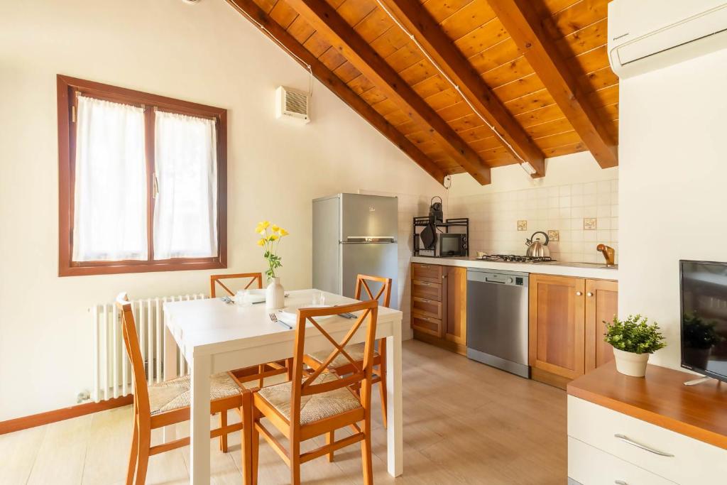 a kitchen with a table and chairs in a room at TRAIN HOUSE in Treviso