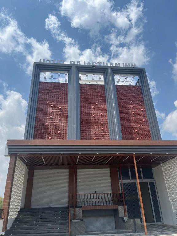 a red brick building with windows on top of it at Hotel Rajasthan Inn in Behror