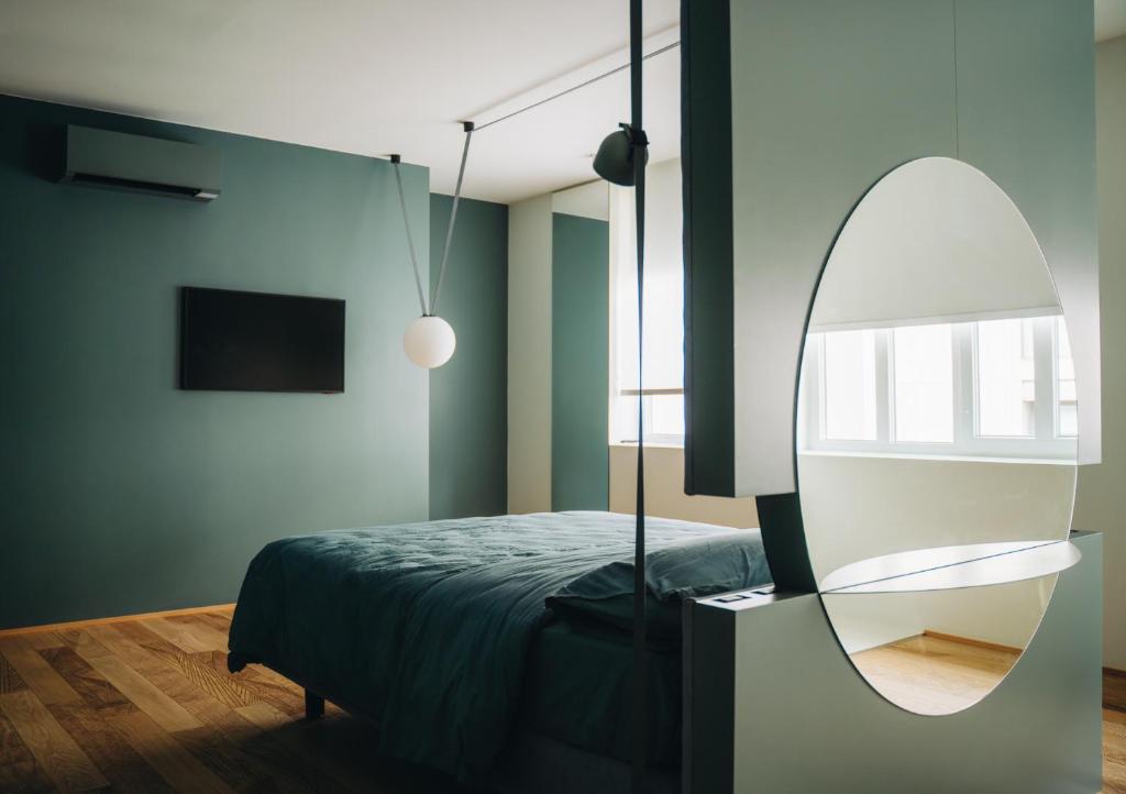 a bedroom with a bed and a mirror at Mafrica House in Aosta