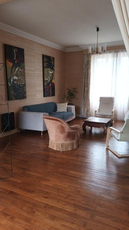 a living room with a couch and a table at La vie en couleur in Clohars-Carnoët