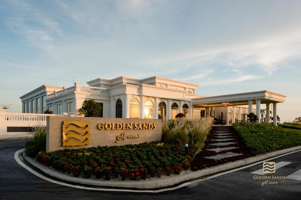 a building with a sign in front of it at Golden Sands Golf Resort in Hue