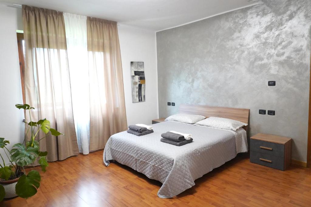 a bedroom with a bed with two towels on it at La CASA DI OLIVER in Pian Camuno