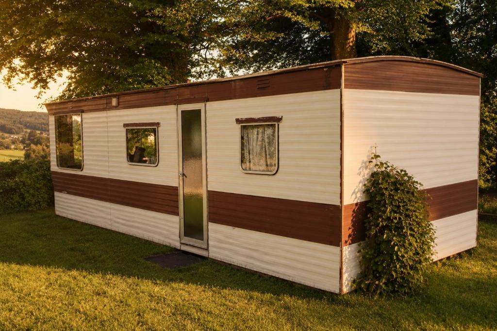 a white and brown tiny house in the grass at Gezellig Chalet Ardennen The Secret View in Amblève