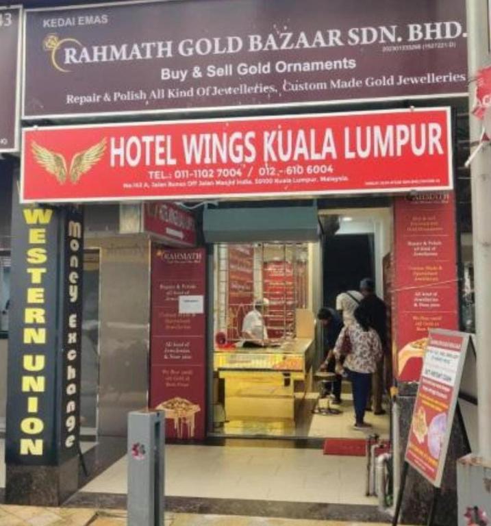 a restaurant with people standing outside of a building at HWKl in Kuala Lumpur