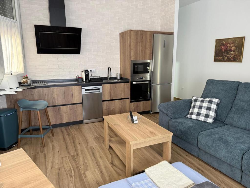 a living room with a couch and a kitchen at Rincon de Toledillo in Plasencia