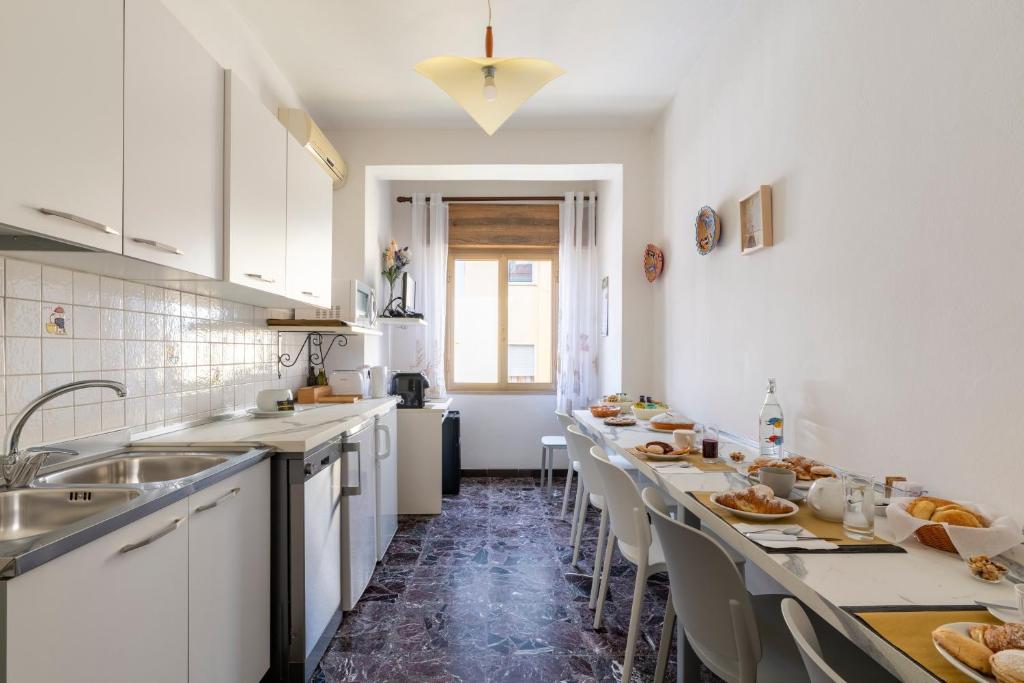 a kitchen with a long table with food on it at B&B Cardedu in Cardedu