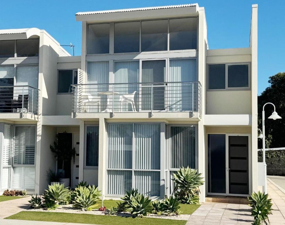 an apartment building with a dog sitting on the balcony at Waves at Jurien, Villa 9-23 Dalton Street in Jurien Bay