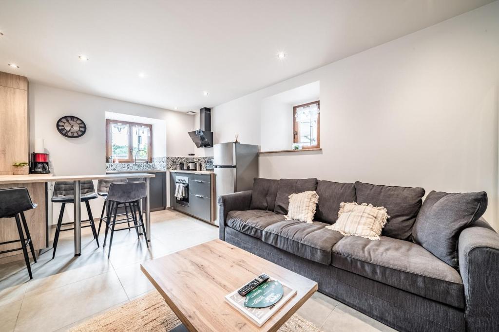 a living room with a couch and a table at Cosy House in Sillingy