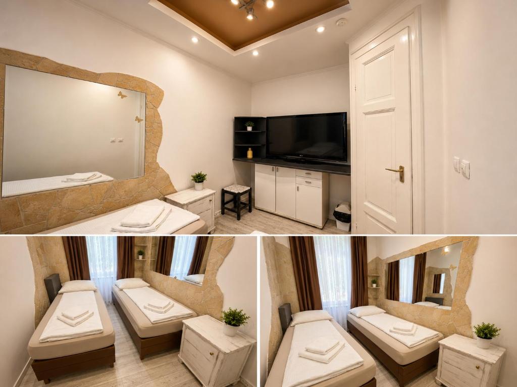 a bathroom with two toilets and a mirror and a television at Centrum Vendégház in Debrecen