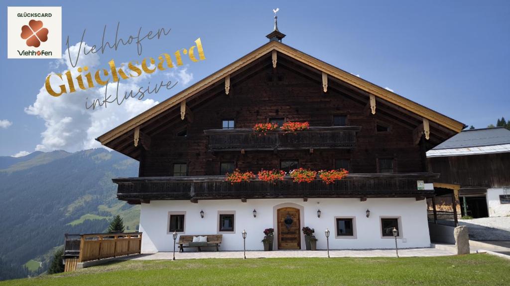 a large wooden building with flowers on the roof at Hecherhof in Viehhofen