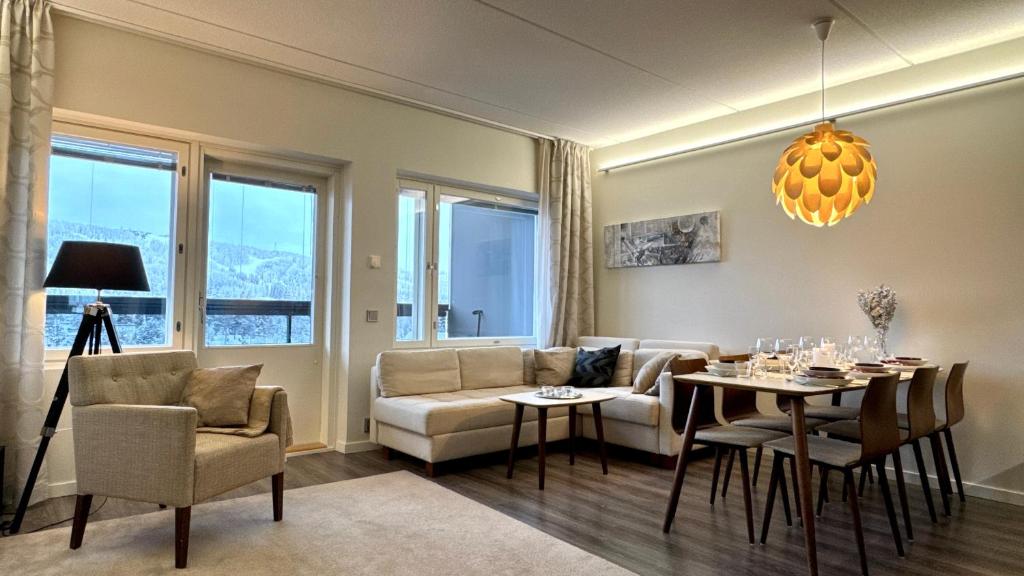 a living room with a couch and a table at Red Apartment 19 in Tahkovuori
