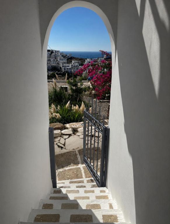 a stairway with a gate and a view of the ocean at MIRA house in Ios Chora