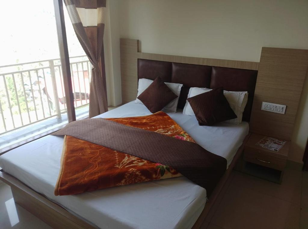 a bed in a room with a large window at Skoon b&b homestay in Shimla