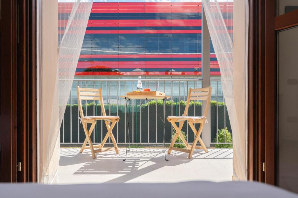 a balcony with two chairs and an american flag at Maranello Suite in Maranello